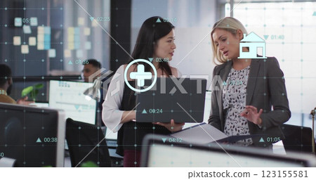 Image of data processing over diverse female colleagues discussing work in office Image of data processing over diverse female colleagues discussing work in office 123155581