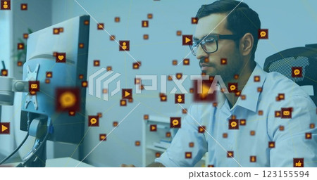 Image of connections with icons over biracial businessman using computer 123155594