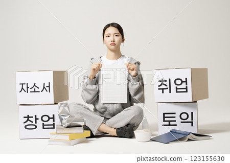 A job seeker in his 20s carrying heavy boxes including personal statements, employment, starting a business, and TOEIC. 123155630