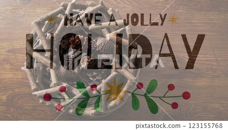 Have jolly holiday text image over holiday decorations with pinecones and branches 123155768