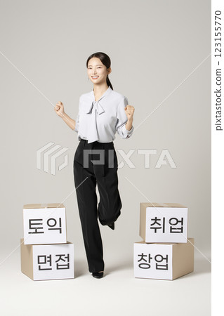 A woman in her 20s wearing a suit who successfully found a job 123155770