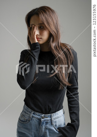 A woman in her 20s suffering from a headache A woman in her 20s suffering from a headache 123155976