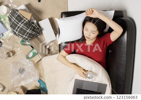A young man in his 20s suffering from burnout, helpless in a messy room A young man in his 20s suffering from burnout, helpless in a messy room 123156063