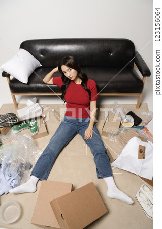 A young man in his 20s suffering from burnout, helpless in a messy room 123156064