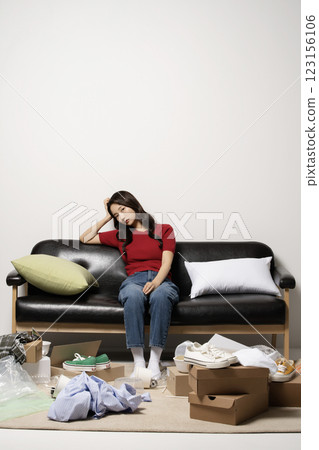 A young man in his 20s suffering from burnout, helpless in a messy room A young man in his 20s suffering from burnout, helpless in a messy room 123156106