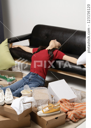 A young man in his 20s suffering from burnout, helpless in a messy room A young man in his 20s suffering from burnout, helpless in a messy room 123156120