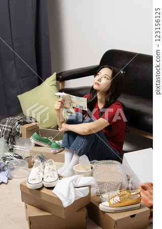 A young man in his 20s suffering from burnout, helpless in a messy room 123156125