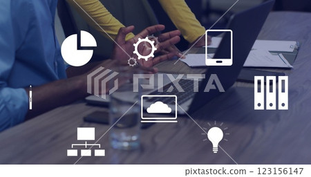 Business icons image over people working with laptops and tablets in office 123156147