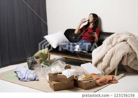 A young man in his 20s suffering from burnout, helpless in a messy room A young man in his 20s suffering from burnout, helpless in a messy room 123156156