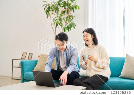 一對夫婦一邊看著電腦顯示器一邊聊天 一對夫婦一邊看著電腦顯示器一邊聊天 123156286