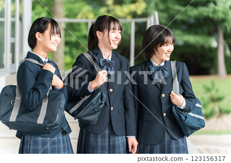 Friendly female students walking through the school building with smiles on their faces (going to school, going home, commuting to school) Friendly female students walking through the school building with smiles on their faces (going to school, going home, commuting to school) 123156317