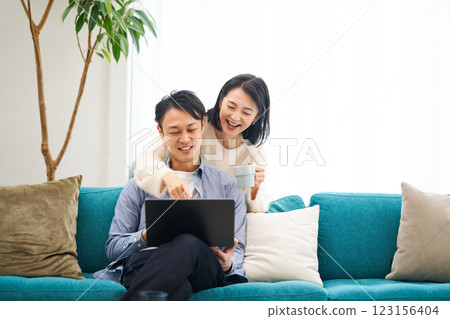 一對夫婦一邊看著電腦顯示器一邊聊天 123156404