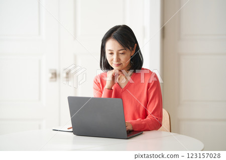 A woman studying at a computer 123157028