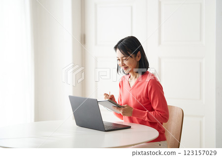 A woman studying at a computer 123157029