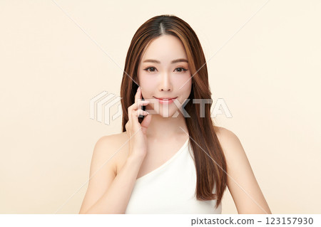 Beautiful young asian woman with clean fresh skin on beige background, Face care, Facial treatment, Cosmetology, beauty and spa, Asian women portrait. 123157930