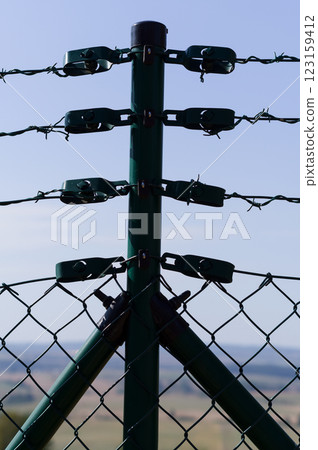 Close-up view of fencing that is made of steel wire. A device that prevents the entry of strangers and animals. Close-up view of fencing that is made of steel wire. A device that prevents the entry of strangers and animals. 123159412