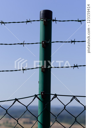 Close-up view of fencing that is made of steel wire. A device that prevents the entry of strangers and animals. Close-up view of fencing that is made of steel wire. A device that prevents the entry of strangers and animals. 123159414