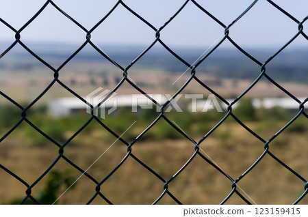 Close-up view of fencing that is made of steel wire. A device that prevents the entry of strangers and animals. Close-up view of fencing that is made of steel wire. A device that prevents the entry of strangers and animals. 123159415