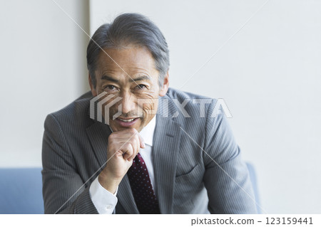 Portrait of a man in his 60s smiling at the camera Portrait of a man in his 60s smiling at the camera 123159441