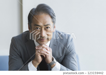 Portrait of a man in his 60s wearing a suit 123159442