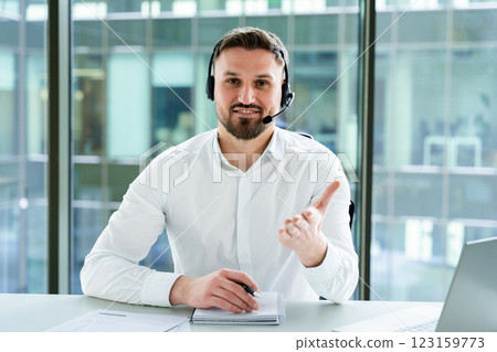 Professional Businessman Engaged in Online Meeting with Headset in Office 123159773