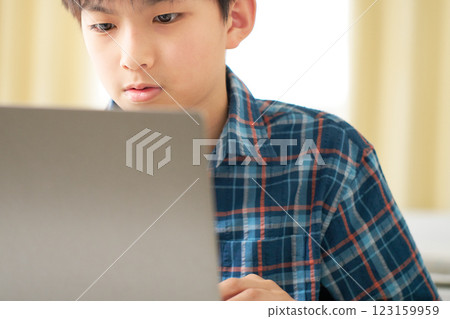 Boy looking at laptop screen 123159959