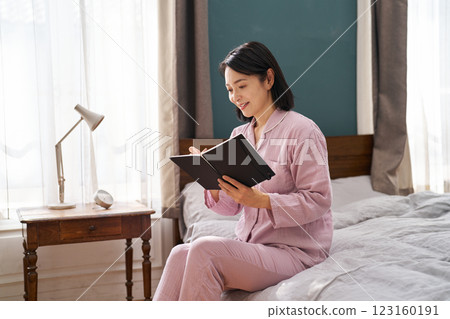 一名女子早晨起床並寫下晨間筆記 123160191