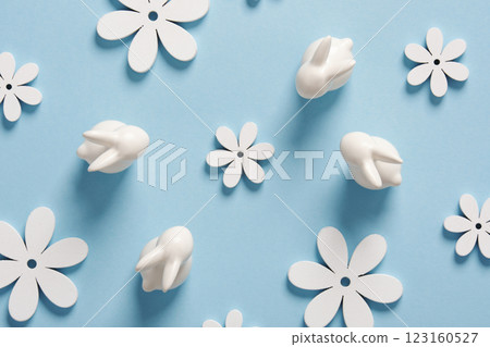 Minimalist Easter pattern with white bunnies and flowers on blue background. Minimalist Easter pattern with white bunnies and flowers on blue background. 123160527