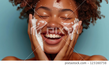 Happy woman cleansing face with bubbly foam Happy woman cleansing face with bubbly foam 123160738