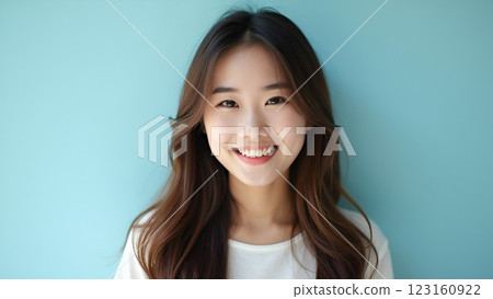 Woman smiling on a blue background 123160922
