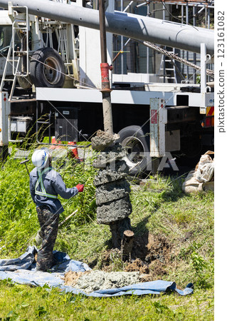 Excavation work for electric pole replacement using a pole digger vehicle Excavation work for electric pole replacement using a pole digger vehicle 123161082