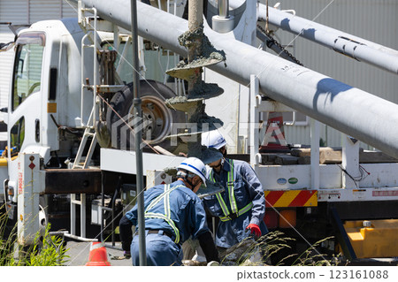 Excavation work for electric pole replacement using a pole digger vehicle 123161088