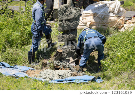 Excavation work for electric pole replacement using a pole digger vehicle Excavation work for electric pole replacement using a pole digger vehicle 123161089