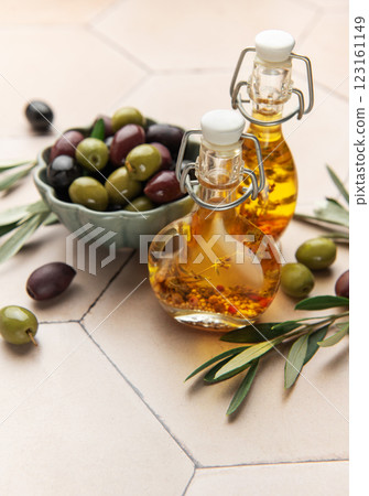 Green and black olives with olive oil on tiled kitchen counter Green and black olives with olive oil on tiled kitchen counter 123161149