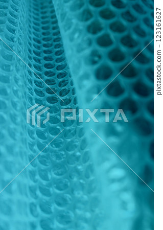Abstract Background With Blue Cells On Folded Mesh Structure. Pattern Of Abstract Blue Elements In A Rows Abstract Background With Blue Cells On Folded Mesh Structure. Pattern Of Abstract Blue Elements In A Rows 123161627