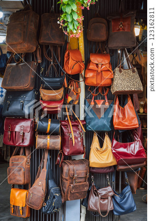 leather bags, belts and accessories on counter in a shop at a street market in Hoi An in Vietnam in Asia leather bags, belts and accessories on counter in a shop at a street market in Hoi An in Vietnam in Asia 123162811