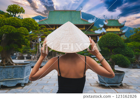 back of woman tourist traveler at Buddhist temple at Linh Ung Pagoda in Da Nang in Vietnam. Concept of travel and tourism in Asia 123162826