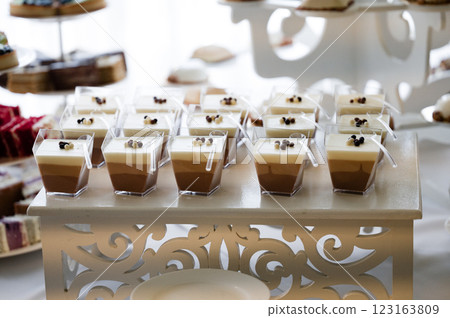 Layered desserts in individual cups at a catered event. Delicious chocolate and vanilla mousse cups. 123163809