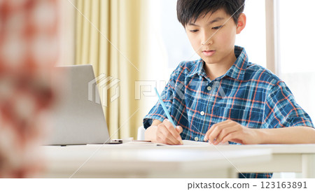 A senior boy studying with a serious expression A senior boy studying with a serious expression 123163891