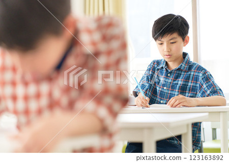 A senior boy studying with a serious expression 123163892