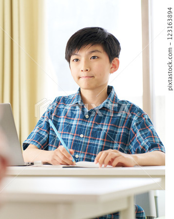 A senior boy studying with a serious expression A senior boy studying with a serious expression 123163894