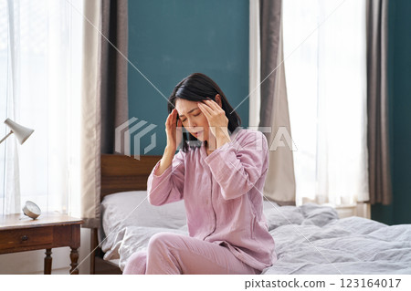 Woman waking up in the morning and suffering from headache 123164017