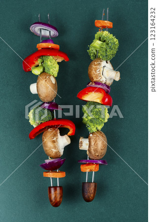 Tasty kebab on skewers with vegetables. Tasty kebab on skewers with vegetables. 123164232