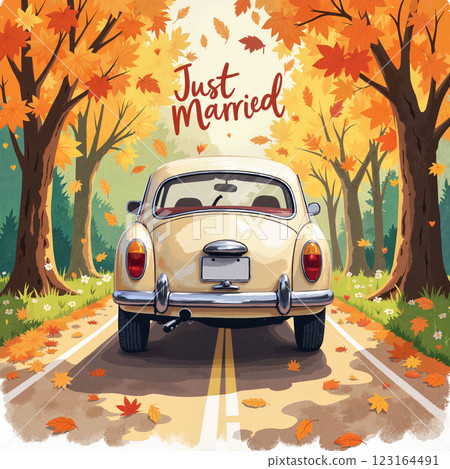 Vintage car drives down a leaf-covered road with trees in autumn hues celebrating recent marriage 123164491