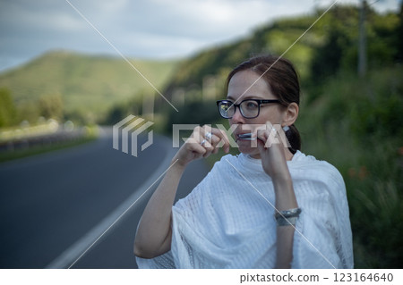 Playing harmonica while enjoying a serene countryside view on a sunny afternoon Playing harmonica while enjoying a serene countryside view on a sunny afternoon 123164640