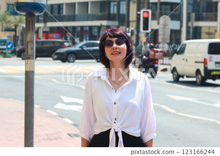 Nicely dressed woman on a sunny hot day in the center of a busy city Nicely dressed woman on a sunny hot day in the center of a busy city 123166244