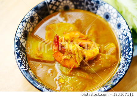 Traditional Thai sour and spicy curry with shrimp and papaya called Kang Som Goong is a healthy, sour and spicy food from the South of Thailand. It is curry without coconut milk. 45-degree view Traditional Thai sour and spicy curry with shrimp and papaya called Kang Som Goong is a healthy, sour and spicy food from the South of Thailand. It is curry without coconut milk. 45-degree view 123167111