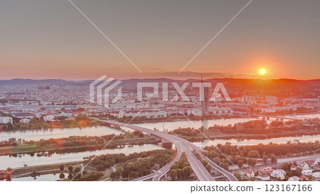 Aerial panoramic view of sunset over Vienna city with skyscrapers, historic buildings and a riverside promenade timelapse in Austria. Aerial panoramic view of sunset over Vienna city with skyscrapers, historic buildings and a riverside promenade timelapse in Austria. 123167166