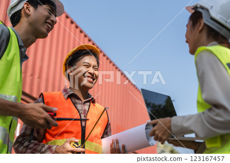 Happy construction team engaging in light hearted discussion engineers collaborating with plans at the site Happy construction team engaging in light hearted discussion engineers collaborating with plans at the site 123167457
