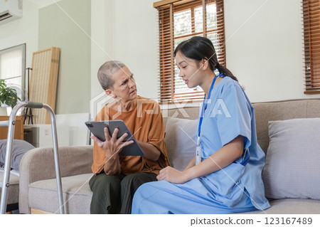 Young Nurse Providing Health Care Advice to Elderly Woman in a Comfortable Home Setting Young Nurse Providing Health Care Advice to Elderly Woman in a Comfortable Home Setting 123167489